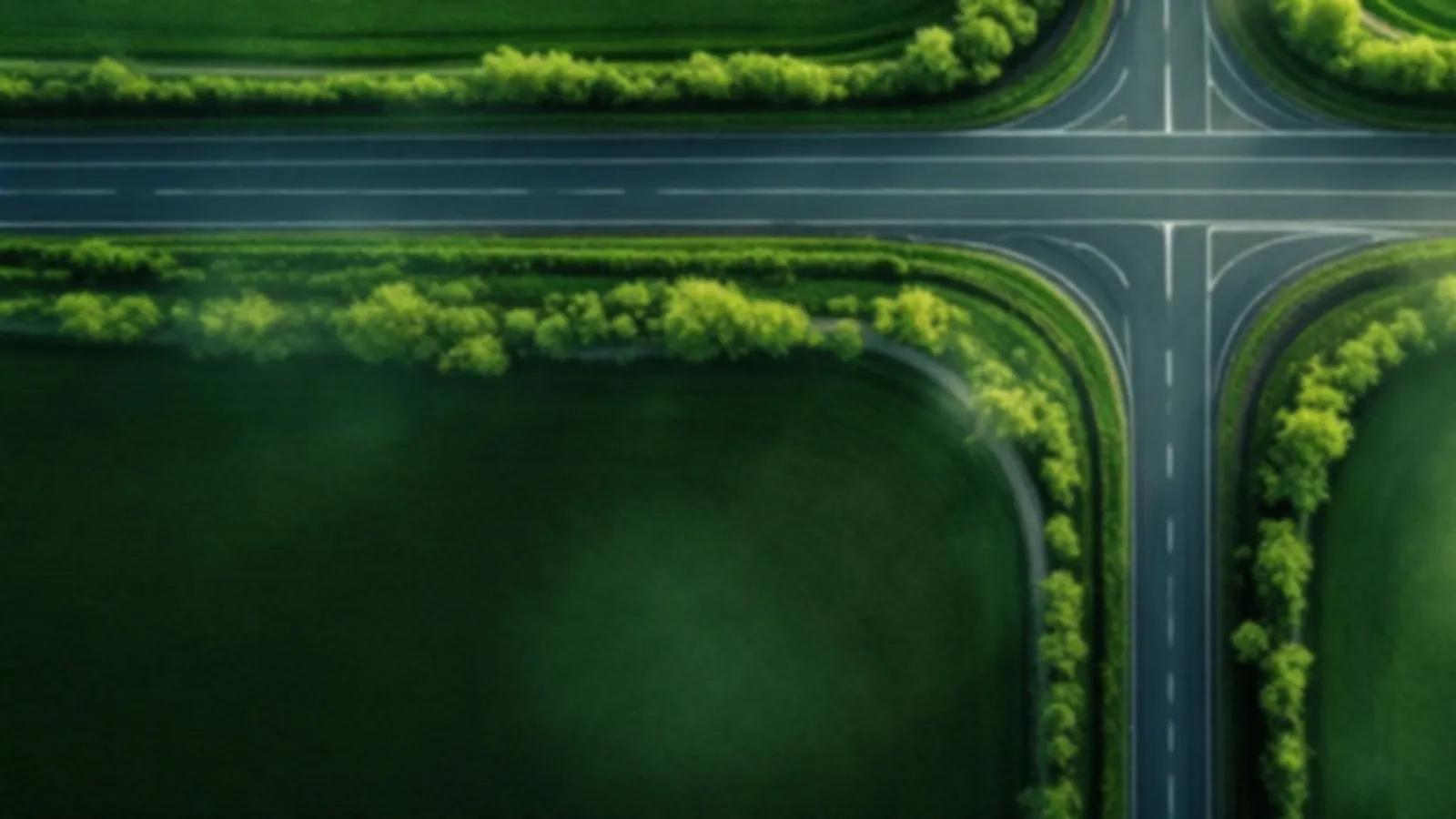 Aerial view of two empty country roads meeting in green farmland under morning mist, the CoupeQuote view of compare loan offers online, $100 – $5,000